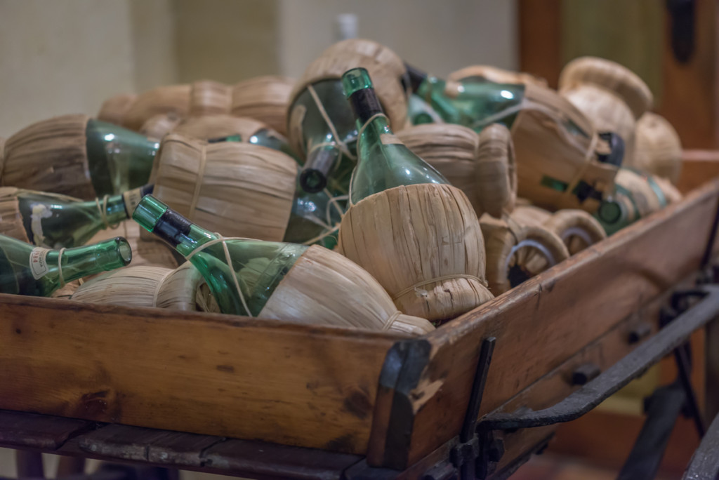 picture of many vintage, wine bottles on the cart